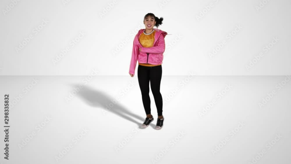 Slow motion of attractive female hip-hop dancer jumping in the studio, isolated on white background Slow motion of attractive female hip-hop dancer jumping in the studio, isolated on white background