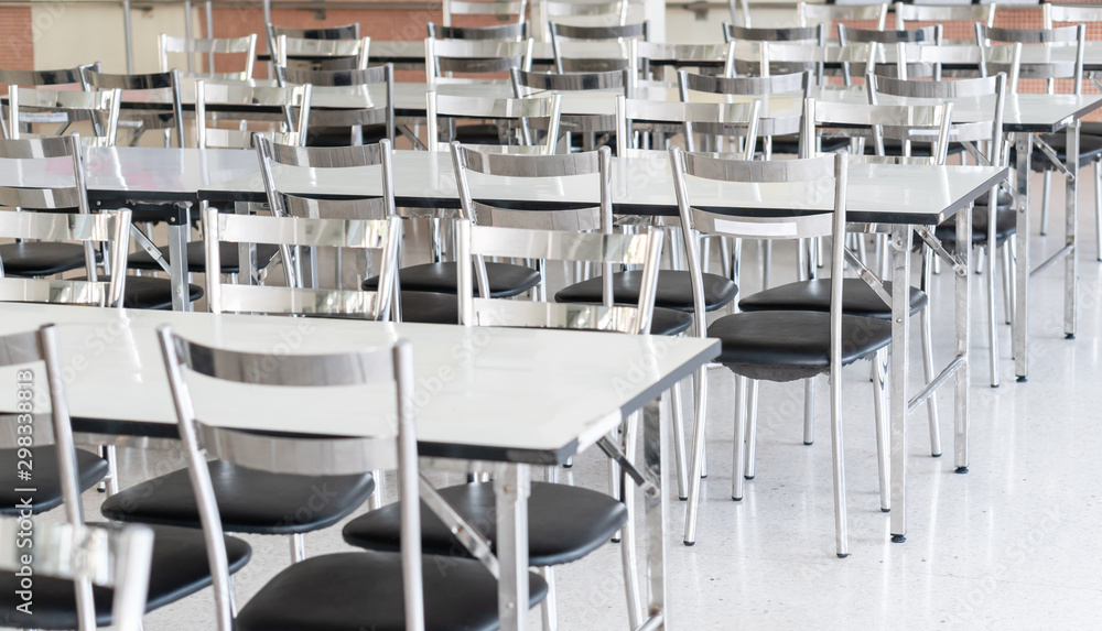 Stainless steel tables and chairs in high school student canteen, public  cafeteria room interior background Stock Photo | Adobe Stock