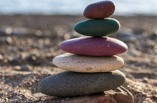 Zen concept. The object of the stones on the beach. Against the sea and pebbles. Multicolor stones. Harmony   Meditation.