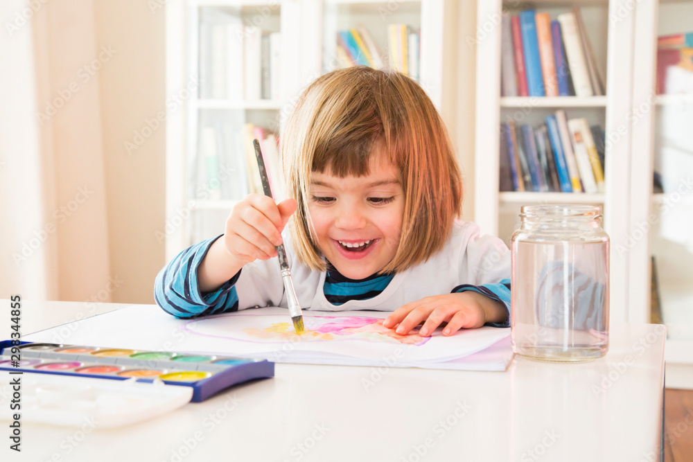 Portrait of smiling little girl painting with watercolours Portrait of smiling little girl painting with watercolours