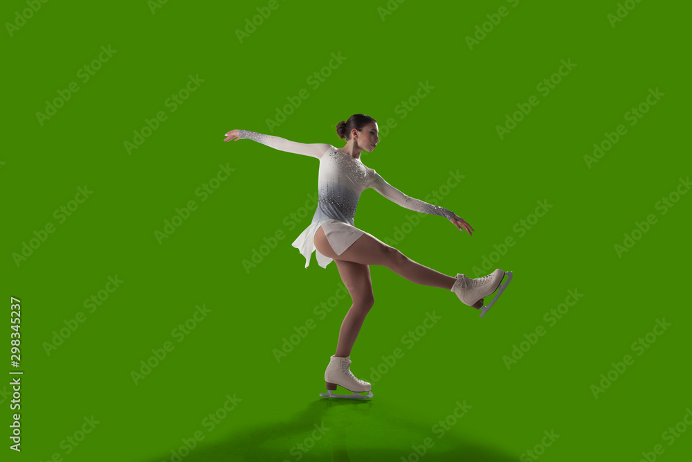 Figure skating girl isolated on green background.