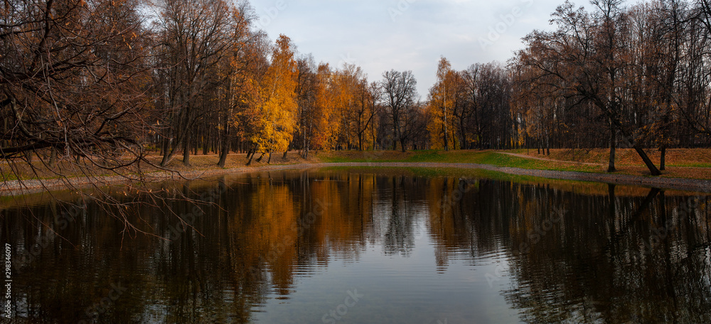 Fall landscape: lake and trees with reflections on a water