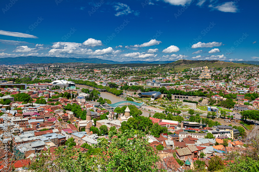 Tbilisi, Georgia - May 9, 2017. Panorama of the central part of the ancient city and the main attractions of the capital of Georgia. Sunny day, blue sky with clouds.