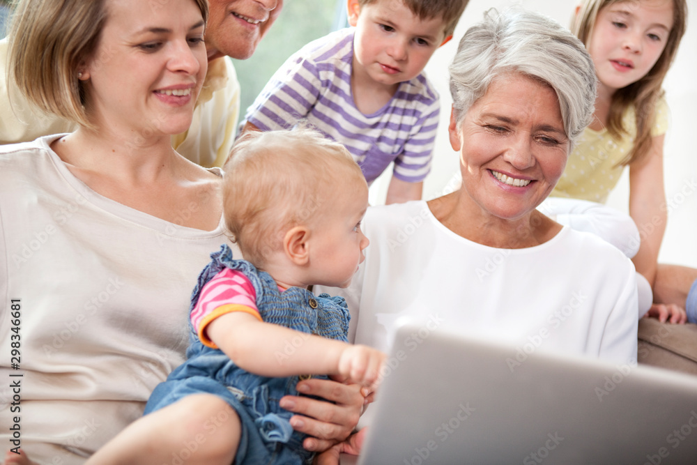 Extended family on couch using laptop Extended family on couch using laptop