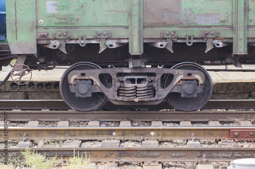 A pair of wheels of a freight train close up photo