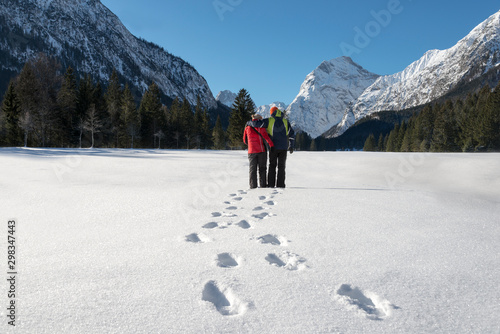 Austria, Tyrol, Pertisau, couple standing in winter landscape