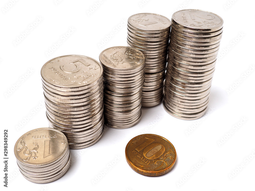 Piles of Russian coins stand on a white paper background. Not isolated. Close-up. News about the economy, commercial banks and the central bank of Russia Piles of Russian coins stand on a white paper background. Not isolated. Close-up. News about the economy, commercial banks and the central bank of Russia