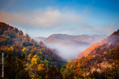 Autumn sunrise on mountain with fog between the hills. National park Djerdap in Serbia.