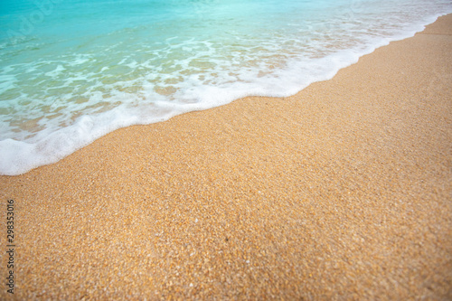 Soft wave of blue ocean selective focus on sandy beach ,On sandy beach background. Travel concept