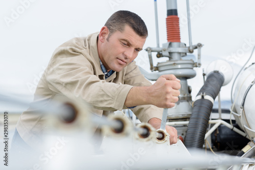 a man fixing an aiplane