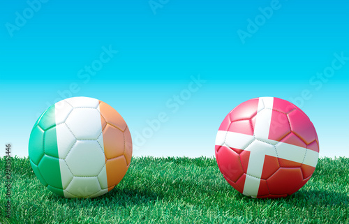 Two soccer balls in flags colors on green grass. Ireland and Denmark. EURO 2020. Group D. 3d image