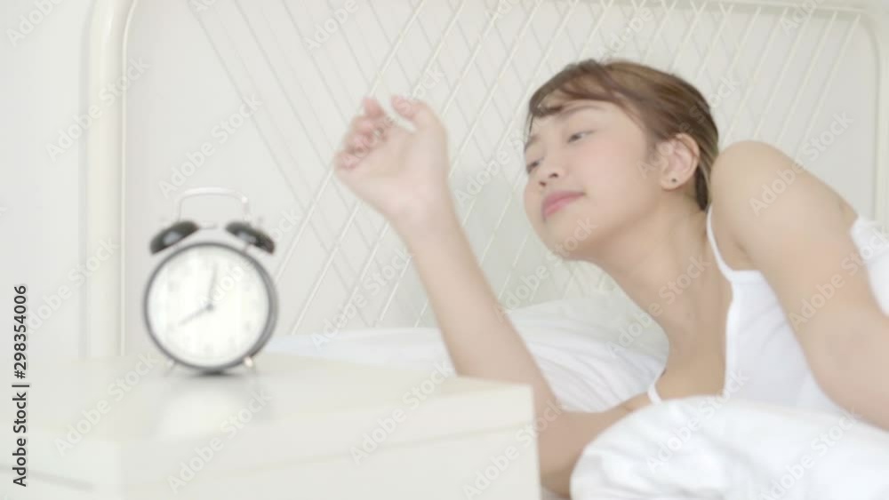 Beautiful young asian woman panicked waking up in the morning looking clock and shock at home, alarm clock late with girl tired and lazy at bedroom, lifestyle concept. Beautiful young asian woman panicked waking up in the morning looking clock and shock at home, alarm clock late with girl tired and lazy at bedroom, lifestyle concept.