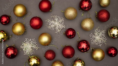 Wallpaper Mural Stop motion of Christmas balls in red and gold color and snowflake appear on grey background  Torontodigital.ca