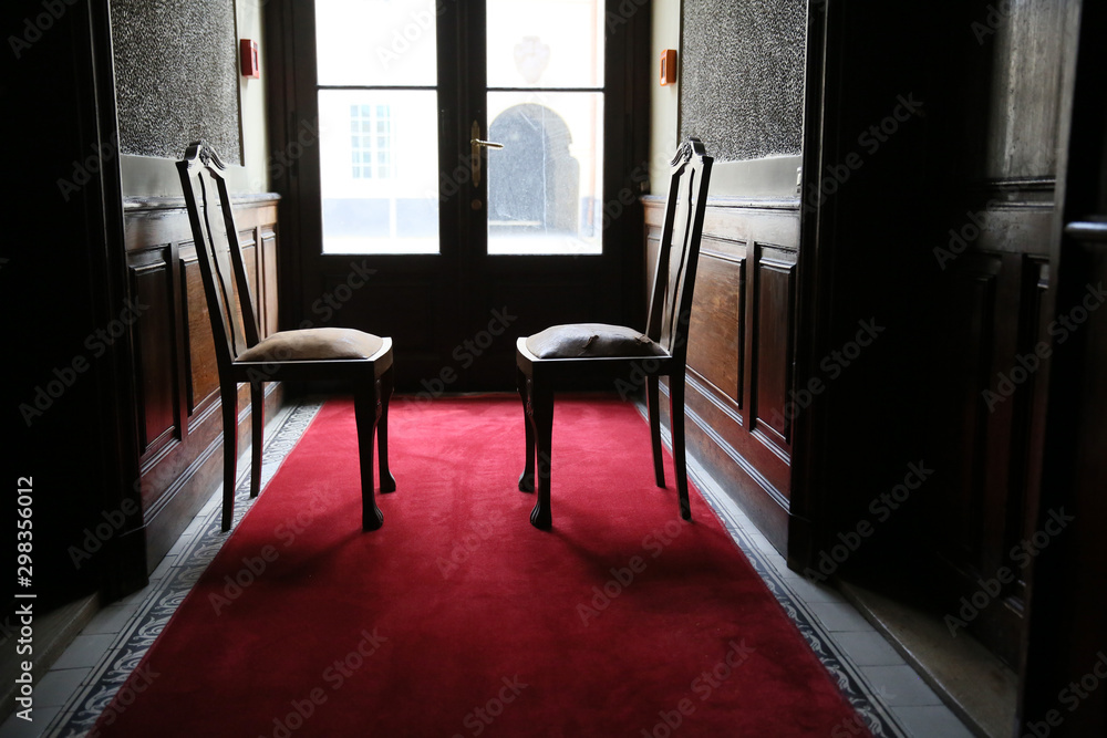 Old very nice and stylish armchair standing in the window Old very nice and stylish armchair standing in the window