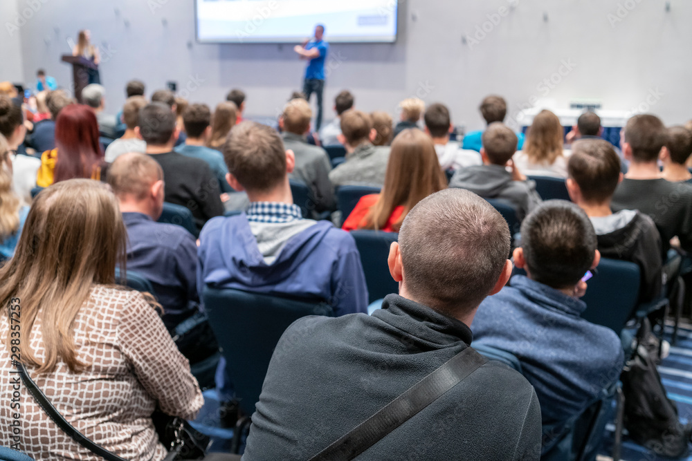 Image of a conference that takes place in a large conference room, workshop for young professionals, training in a large conference room, adult training