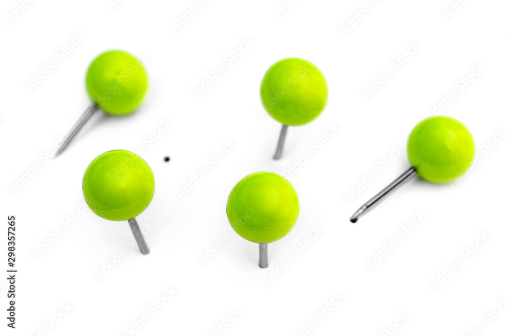 Green small office pins on white. Top view. Green small office pins on white. Top view.