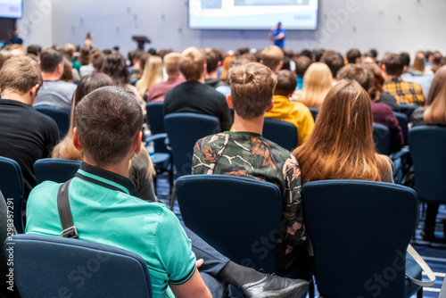 Image of a conference that takes place in a large conference room, workshop for young professionals, training in a large conference room, adult training