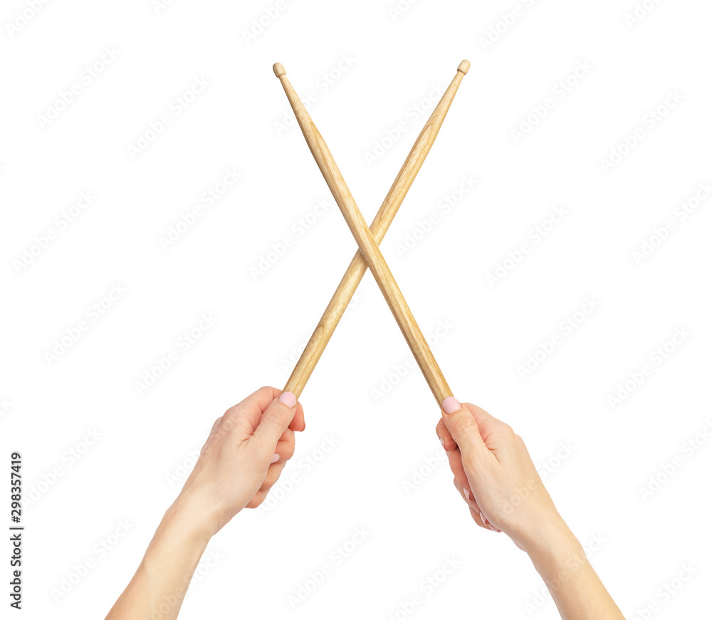 Fototapeta premium Woman's hands holding drum sticks. Isolated on white.