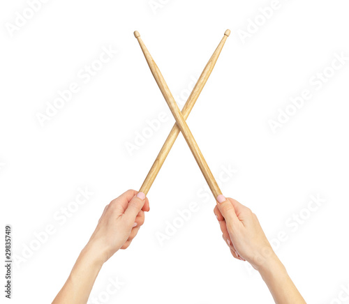 Woman's hands holding drum sticks. Isolated on white.