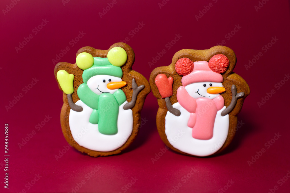 gingerbread cookie of cute snowman on red background. Traditional Christmas food. Christmas and New Year holiday concept. gingerbread cookie of cute snowman on red background. Traditional Christmas food. Christmas and New Year holiday concept.