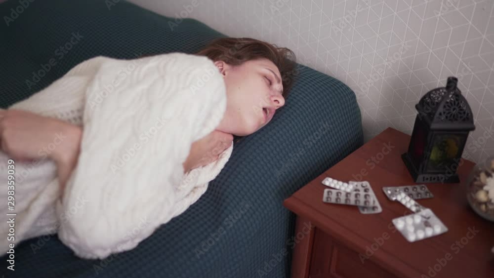 Symptoms of the common cold. Unhealthy Caucasian woman with the flu. Flu virus, temperature and cough Symptoms of the common cold. Unhealthy Caucasian woman with the flu. Flu virus, temperature and cough