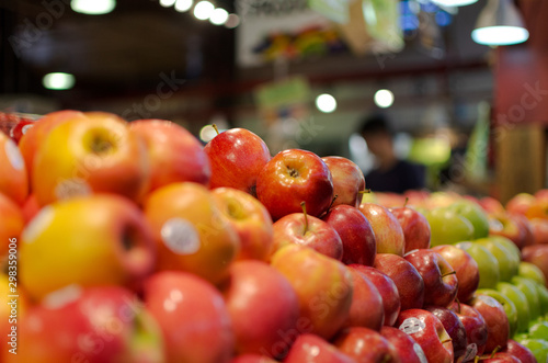 Red apples neatly stacked in a grocery store 