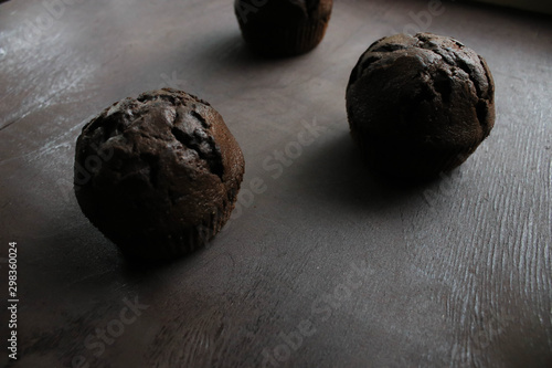 Chocolate cupcakes on brown background
