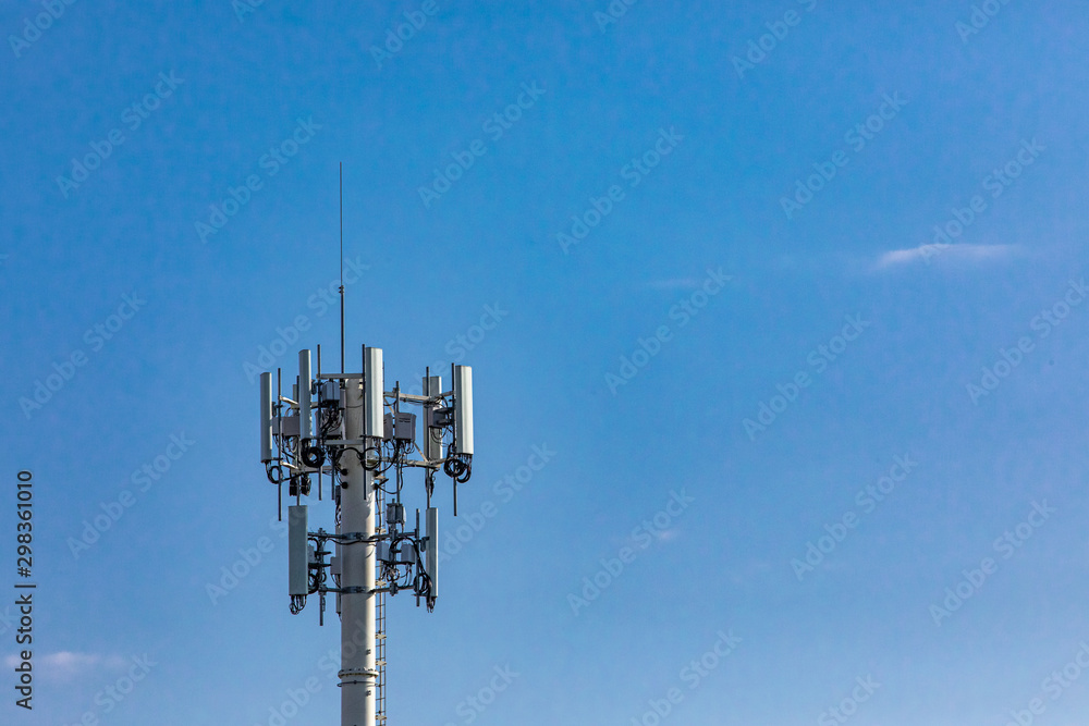 A close up view on the top of a cell site pole, used for the transmission and receiving of mobile network signals, against a clear blue sky with copy-space. A close up view on the top of a cell site pole, used for the transmission and receiving of mobile network signals, against a clear blue sky with copy-space.