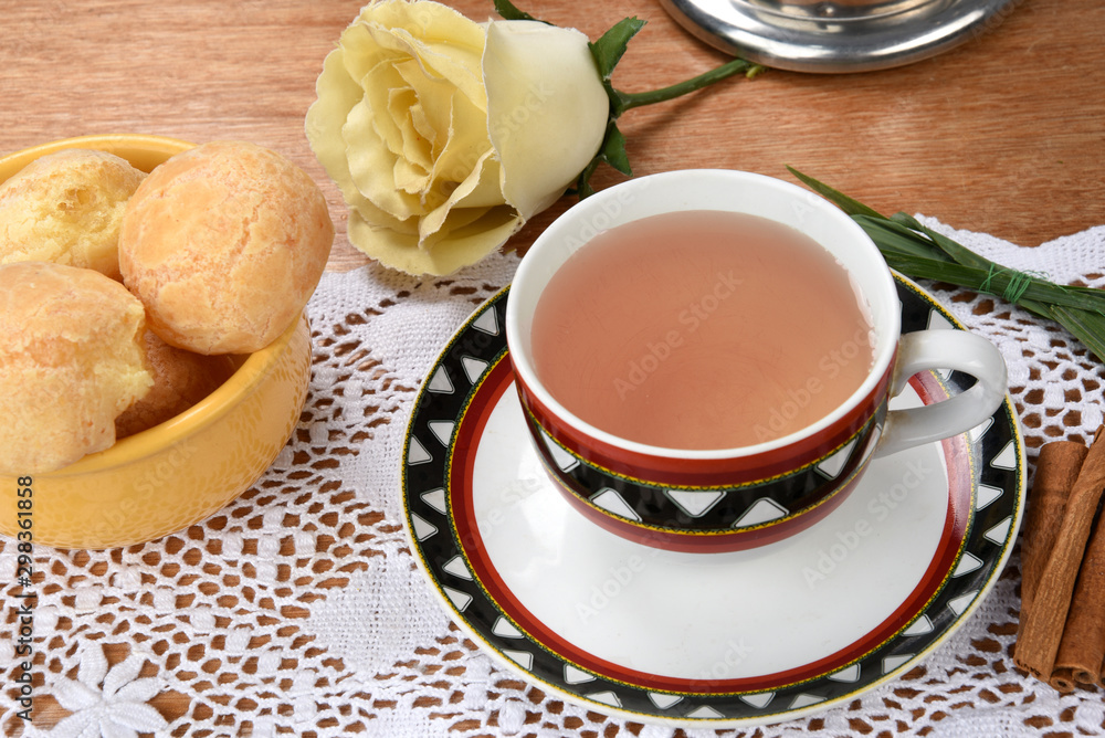 cup of tea with cheese on wooden table, brazilian breakfast cup of tea with cheese on wooden table, brazilian breakfast