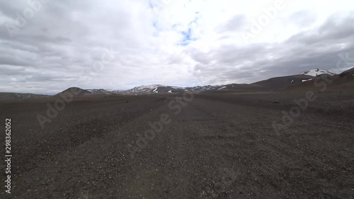 Driving gravel road in Iceland. Camera outdise the car low above road surface photo