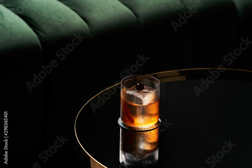 Fresh cocktail glass on glass table in night club restaurant photo