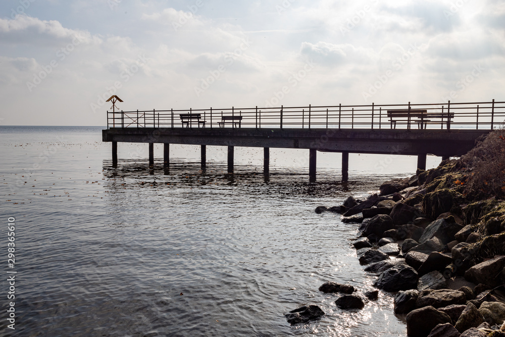 A small pier over the bay in Central Europe. A small bridge over the sea.