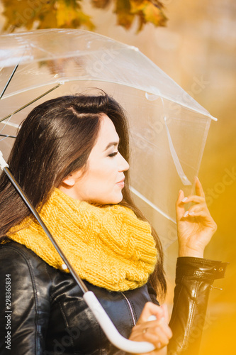 фотографія Beautiful attractive girl of oriental appearance brunette in autumn under a tran