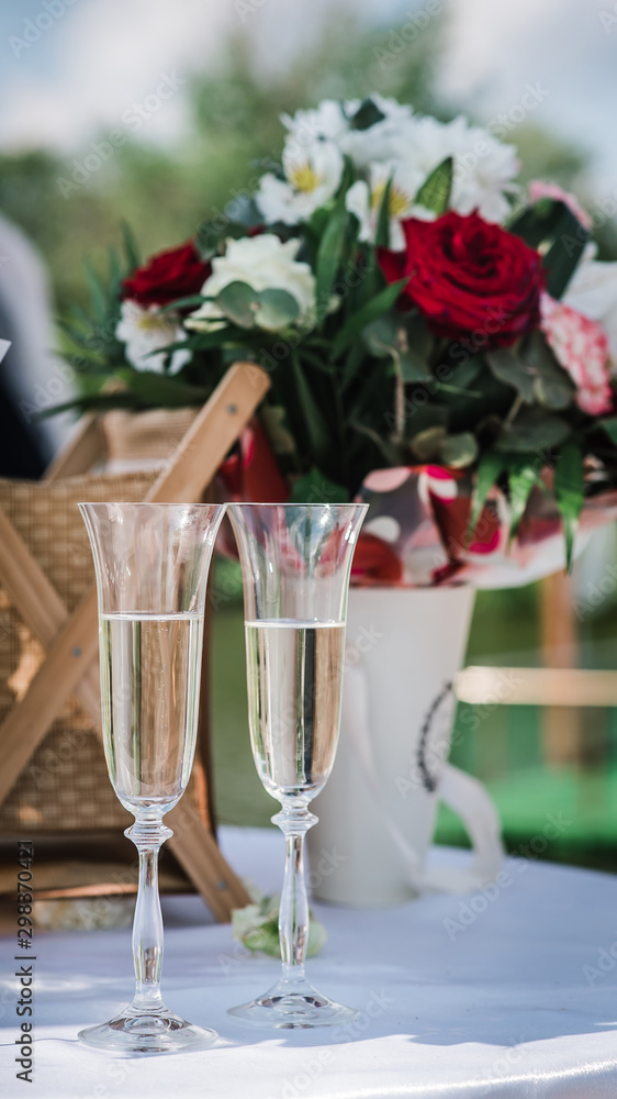 glasses with champagne at a wedding on the background of the newlyweds 2 glasses with champagne at a wedding on the background of the newlyweds 2