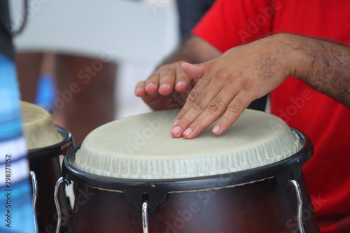 Hands playing a latin drum