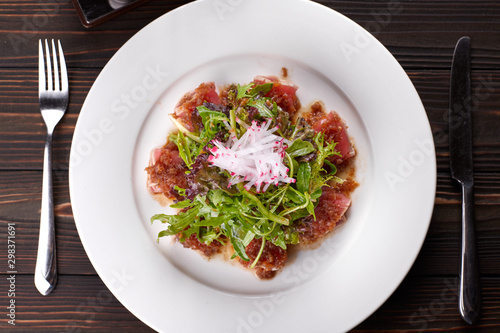 Fish salad. Tuna and rucola. on a white plate