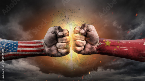 USA vs China. Fists with flags. Battle of two countries on sky.