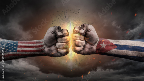 Photography USA vs Cuba. Fists with flags. Battle of two countries on sky.