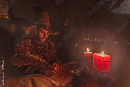 Nostradamus writing his prophesies, fantasy concept. illuminated by candles, long exposure, motion blur, high ISO