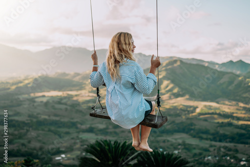 Beautiful view of young woman swing on the top of the mountan Redonda in Dominican Republic. Concept travel, vacation