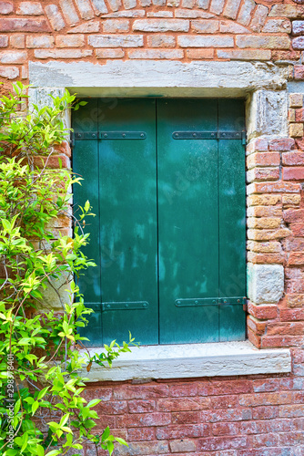 Green window shutters seen in Venice