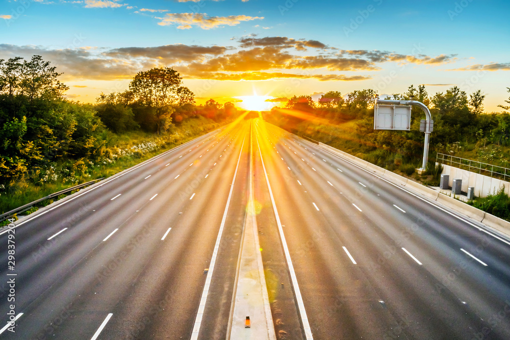 empty UK motorway in England at sunset with no traffic - obrazy, fototapety, plakaty 