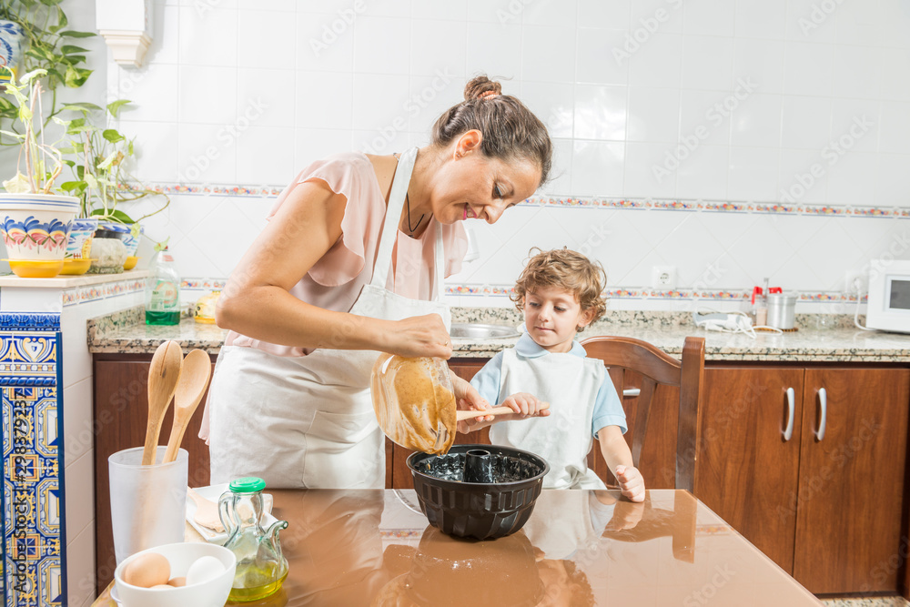 A woman and a child cooking.