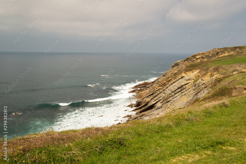 Cliffs in the sea with a cloudy sky. Cantabrian coast in the Atlantic Ocean.