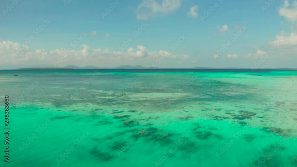 Tropical lagoon with turquoise water, coral reef and tropical islands in the blue sea, top view. Balabac, Palawan, Philippines. Summer and travel vacation concept. Tropical lagoon with turquoise water, coral reef and tropical islands in the blue sea, top view. Balabac, Palawan, Philippines. Summer and travel vacation concept.