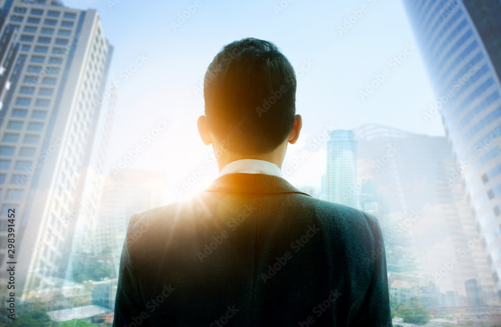 Smart business man is standing and wearing suit uniform. Double exposure on city landscape. Smart business man is standing and wearing suit uniform. Double exposure on city landscape.