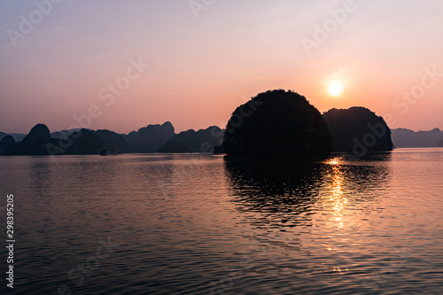 Sunset over the cast mountains of halong bay vietnam