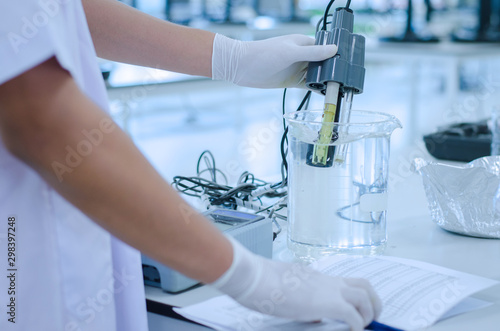 scientist used chemical solution and lab testing for water quality or ph meter in laboratory ,research and science concept