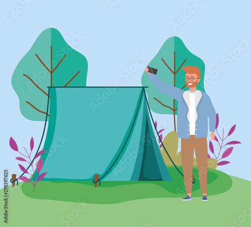 man taking selfie foliage tent camping picnic