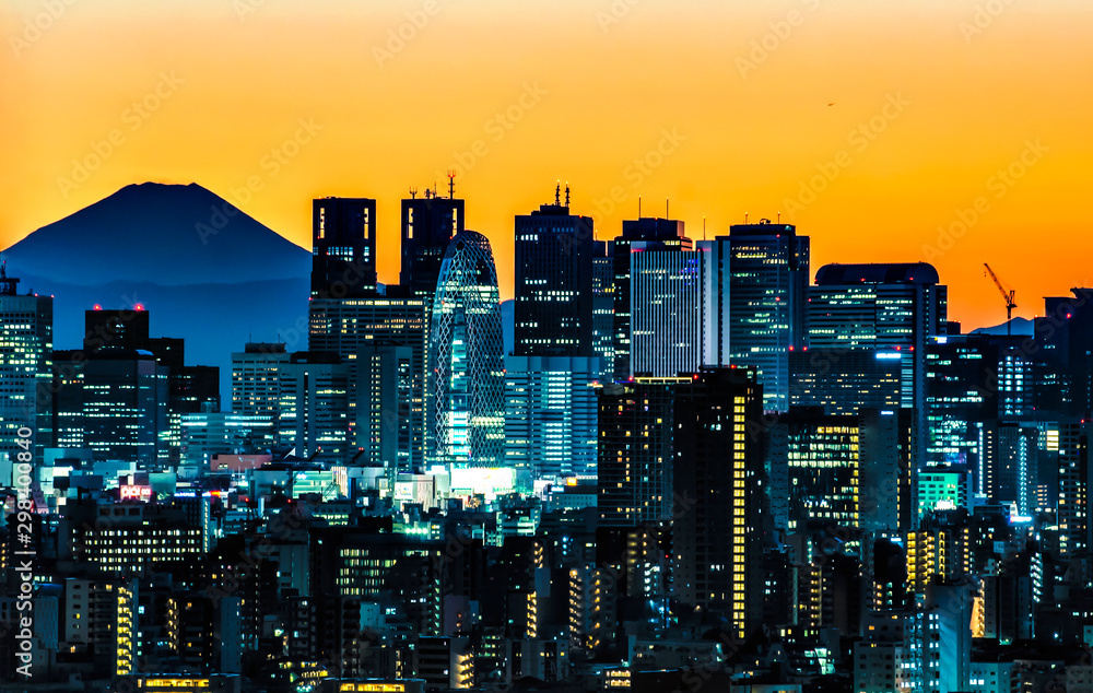 Illumination of Shinjuku Skyscraper Buildings and Fuji Mountain Background at Sunset, Tokyo, Japan